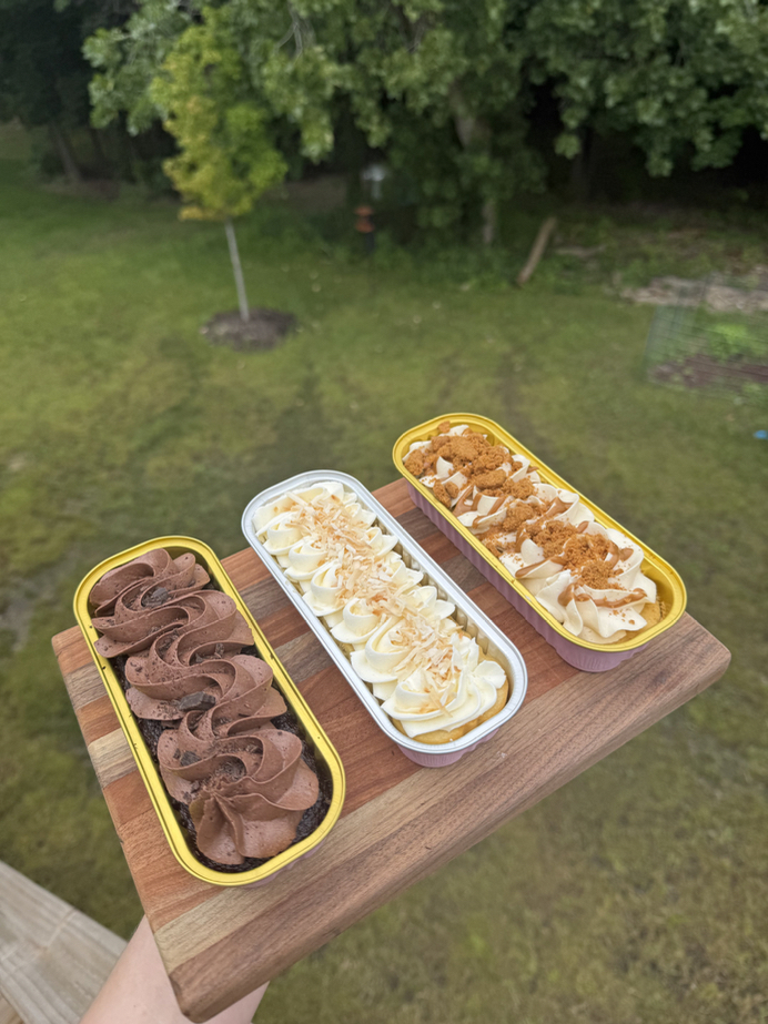Assorted mini cakes on a wooden board